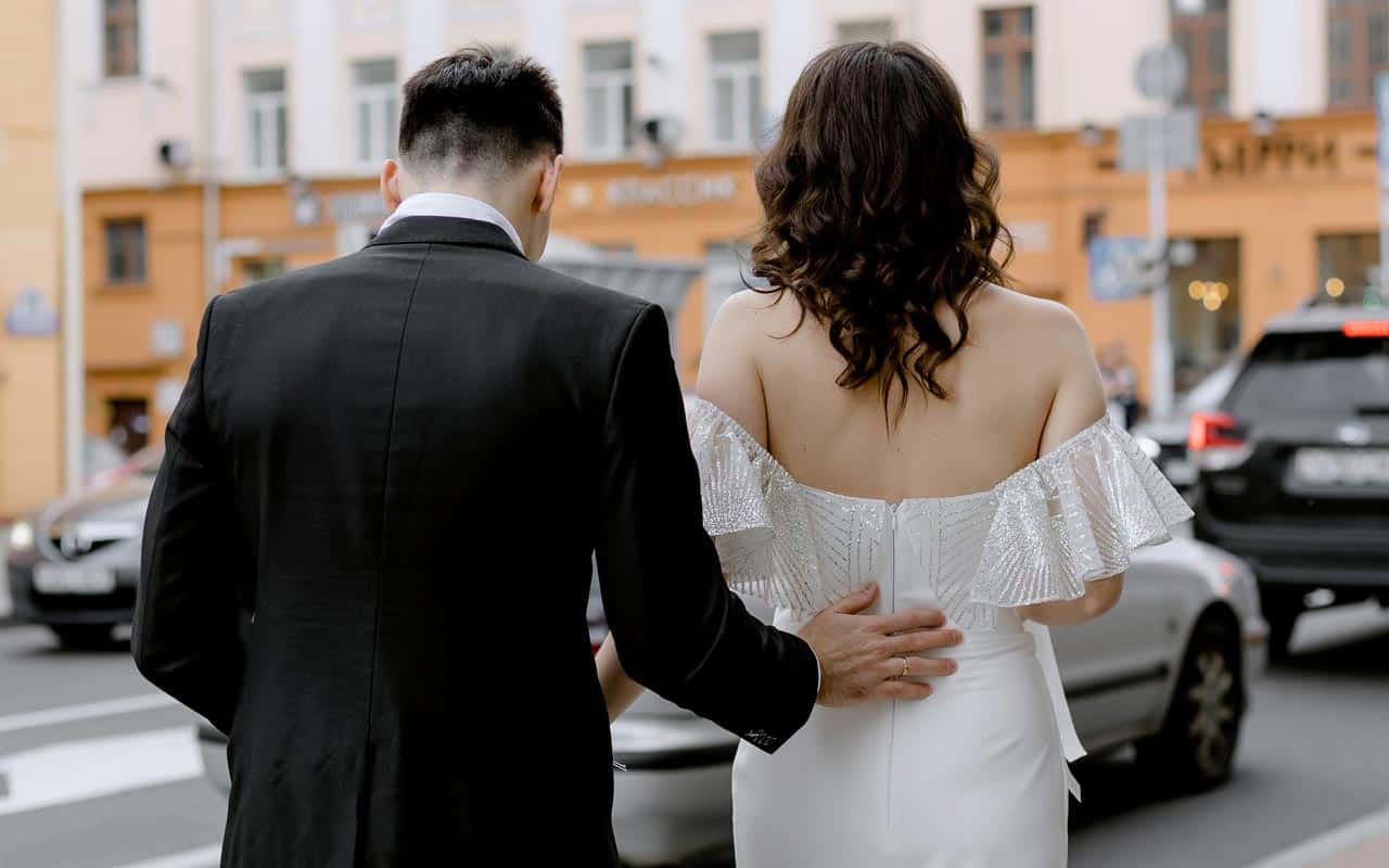 Man touching woman on the small of back to try and move out of the friend zone