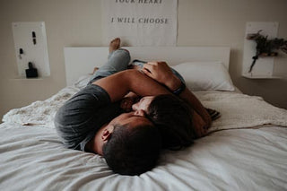 man trying to maintain climax control with woman in bed