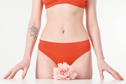 Woman with flower representing a happy vagina after discovering vaginal numbing cream