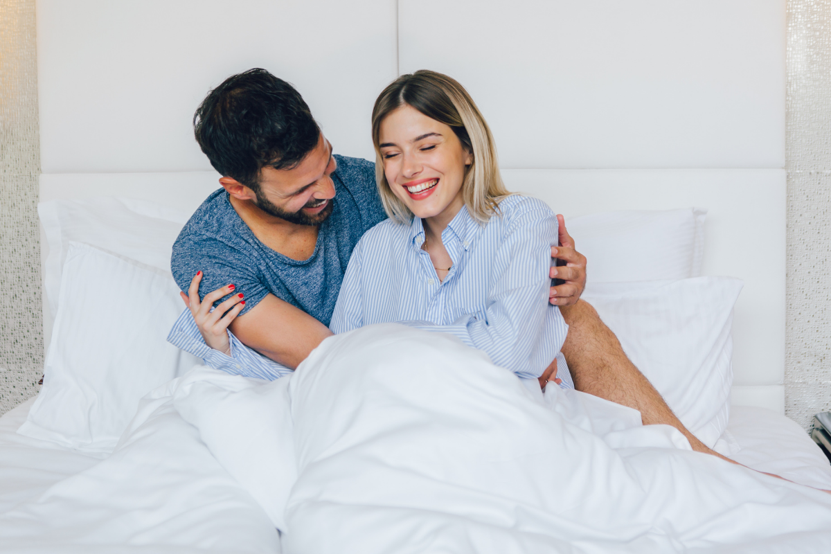 Couple in bed representing natural remedies to improve sexual performance.